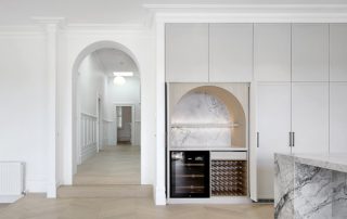 Bespoke Wine Cellar | Architectural Joinery | Luxury Design Luxurious, architecturally designed wine cellar with a round arch detail, bespoke timber dowel wine storage, and a natural stone bench top.