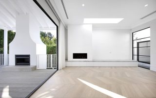 High End Joinery in Indoor Outdoor Entertaining Area Indoor outdoor entertaining and living space with fireplace and high end architectural joinery in white.