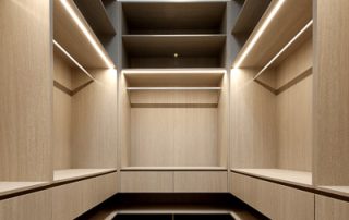 Bespoke Walk-In Wardrobe: Exquisite Joinery and Custom Lighting Close-up of bespoke design walk-in wardrobe joinery with custom lighting.