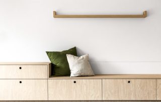 Contemporary Pool House Design | Bench Seating A bespoke bench seat for the pool house featuring a low profile, a Laminex - Raw Birchply finish, and abundant storage in the custom joinery.