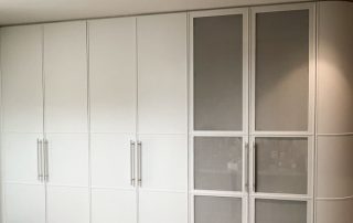 Bespoke Bar Unit | Custom Curved Door A bespoke cabinetry unit comprising two sets of double door cabinets, door paneling with woven metal mesh inserts, and a custom design double curved door.