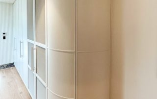 Bespoke Double Curved Doors | Precision Joinery A white custom design cabinetry unit featuring a double curved door and multiple double door cabinets.