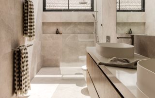 Modern Bespoke Bathroom: Seamless Integrated Design A light-filled contemporary ensuite with a bespoke floating vanity. Features include custom drawers with sharknose fingerpulls adding a streamlined effect and a crisp white countertop with dual sinks, completed with a custom mirror.