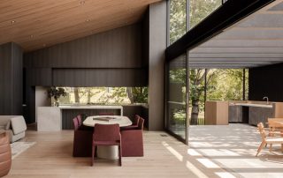 Seamless Kitchen Design | Indoor Outdoor Living Integration A contemporary luxury home with an indoor and outdoor kitchen. Large sliding glass doors showcase the indoor-outdoor flow between spaces.