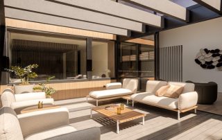 Modern Home Design | Integrated Spaces in Eaglemont An outdoor entertaining area in a neutral, modern style with outdoor seating area and structural overhead beams.