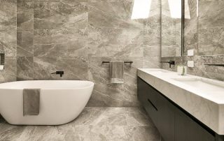 Modern Ensuite Vanity | Sleek Design Modern ensuite vanity with a white countertop featuring a a 'Black Wenge Ravine' finish in a grey stone tiled ensuite.
