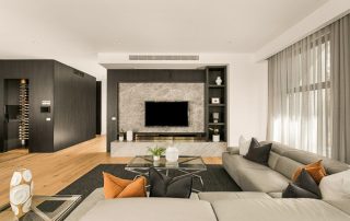 Modern Integrated Entertainment Unit | Custom Joinery Work A wall-integrated entertainment unit with a 'black wenge ravine' finish, featuring a marble TV wall, meticulously framed by bespoke joinery and display shelving, creating a striking contrast and highlighting the craftsmanship of the unit.