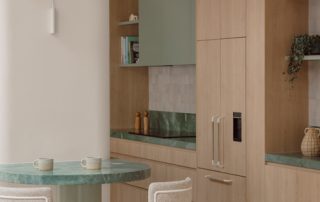 Hampton Residence – Kitchen Island Curved kitchen island with a marble surface, integrated seating, and custom cabinetry in a calm, natural palette.